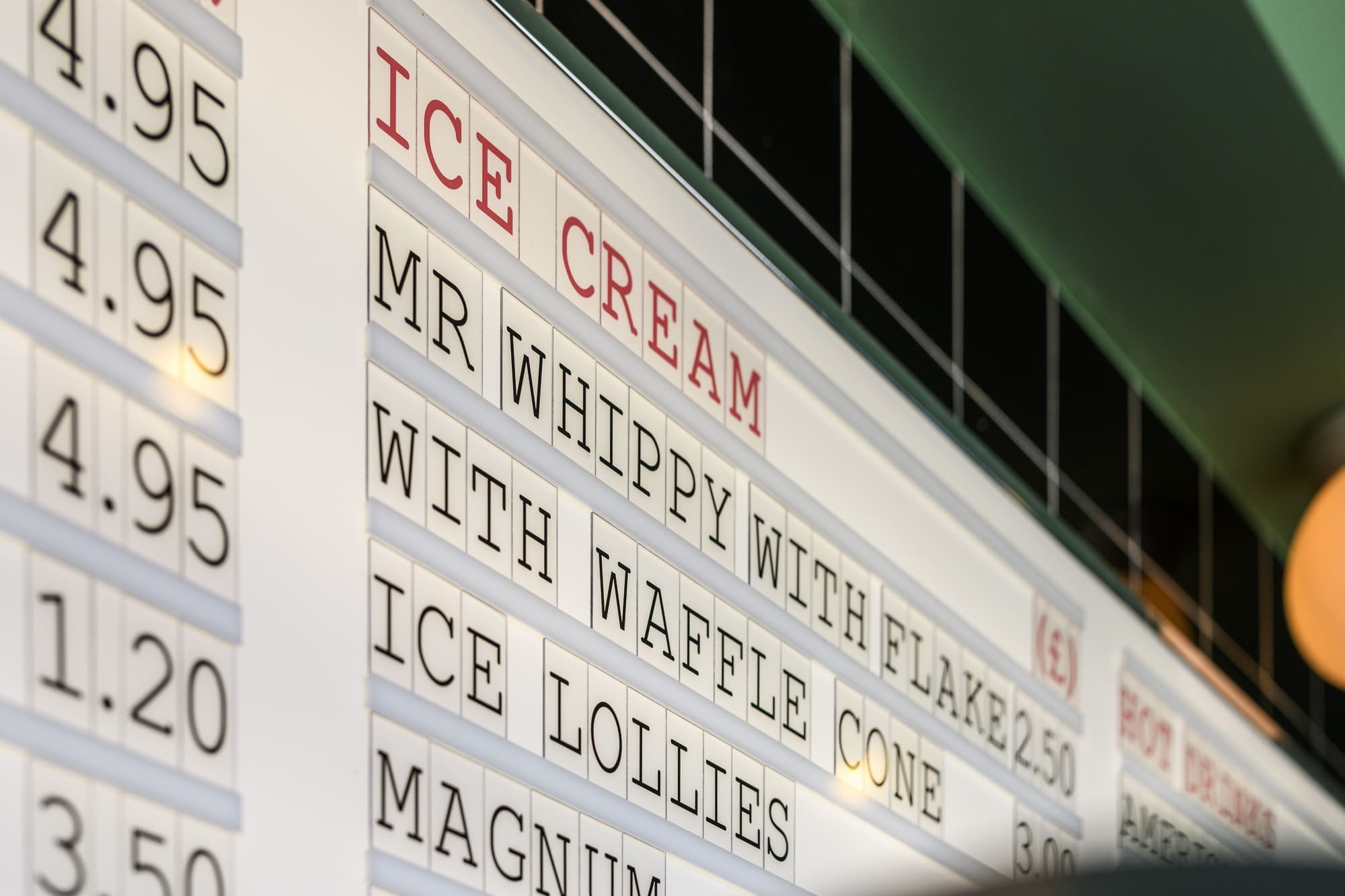 A close-up of a Martello ice cream menu board shows prices and items like "MR WHIPPY WITH FLAKE," "WITH WAFFLE CONE," "ICE LOLLIES," and "MAGNUM" in black letters on a white background.